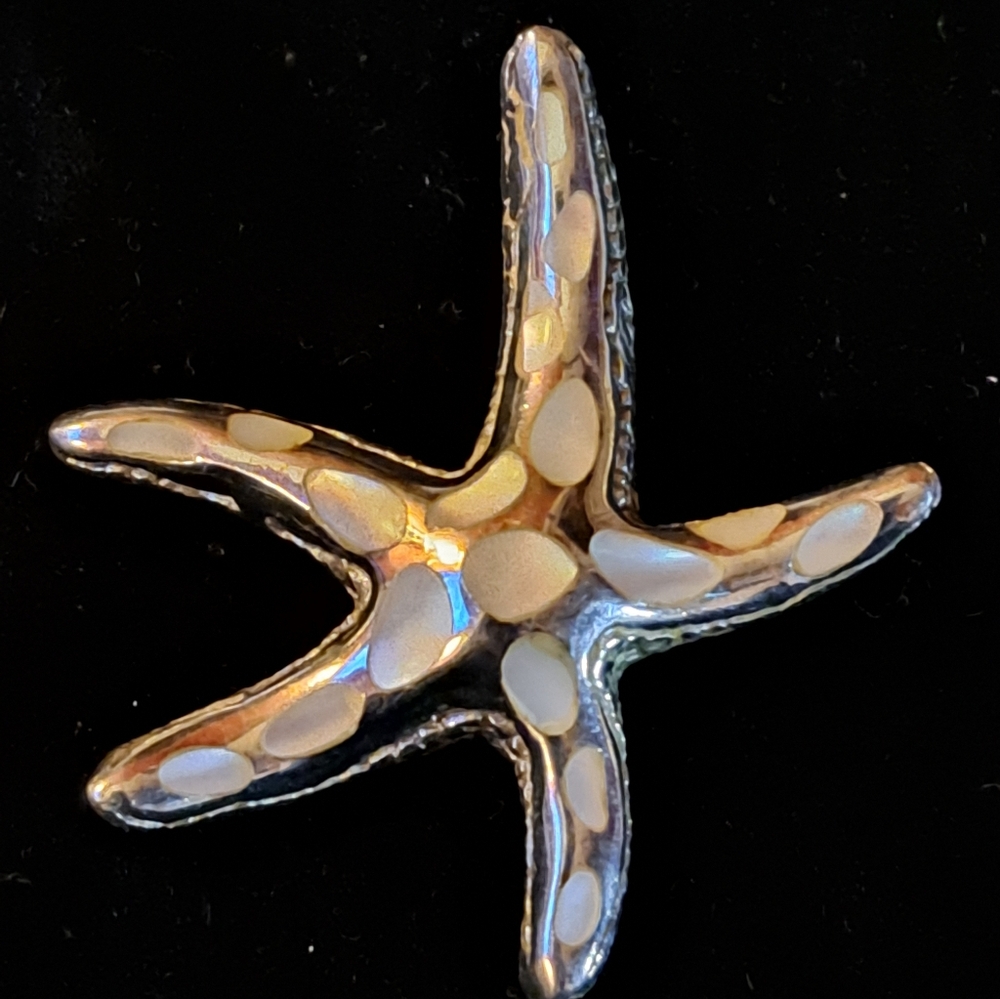 925 Sterling Starfish pendant with Inlaid mother of pearl. Pendant is 1 1/2".